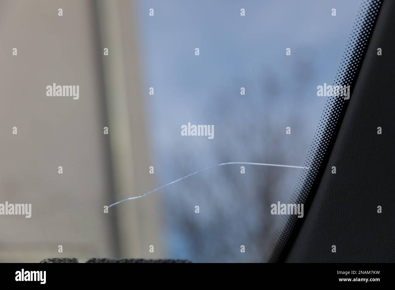 Cracked windshield in the car, closeup of scratches on the glass Stock