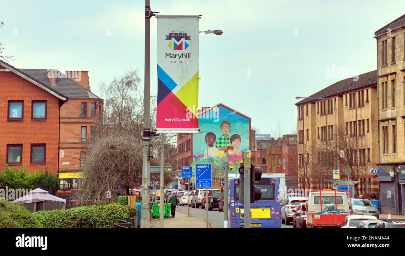 Traffic on Maryhill road district banner with multicultural mural in