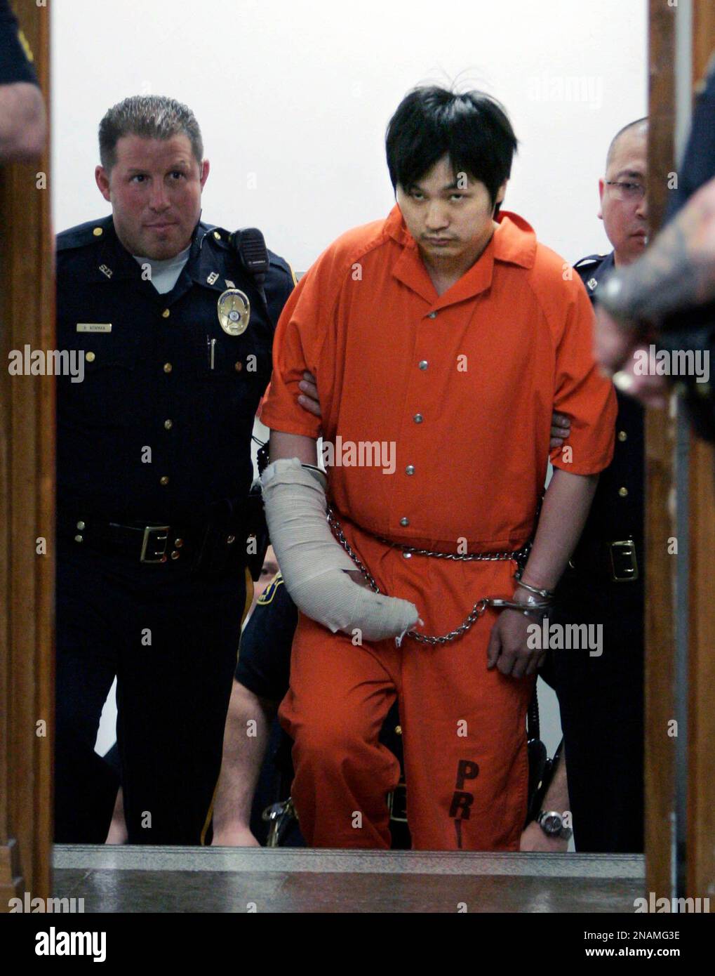 FILE- In this May 21, 2008 file photo, Kang-Hyuk Choi, center, is escorted into court by sheriff's officers at the Bergen County Courthouse in Hackensack, N.J. Choi has been given three concurrent