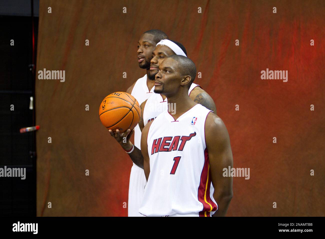 Miami Heat players Dwyane Wade, back, LeBron James, and Chris Bosh pose