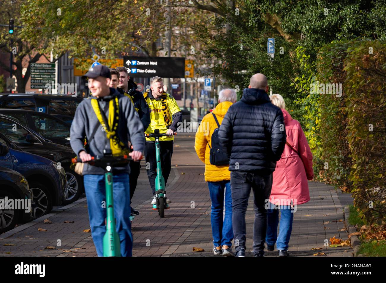 Picture of BVB Borussia Dortmund supporters in Dortmund, Germany, cheering on a electric scooter while going to the footbal stadium of the city. Balls Stock Photo
