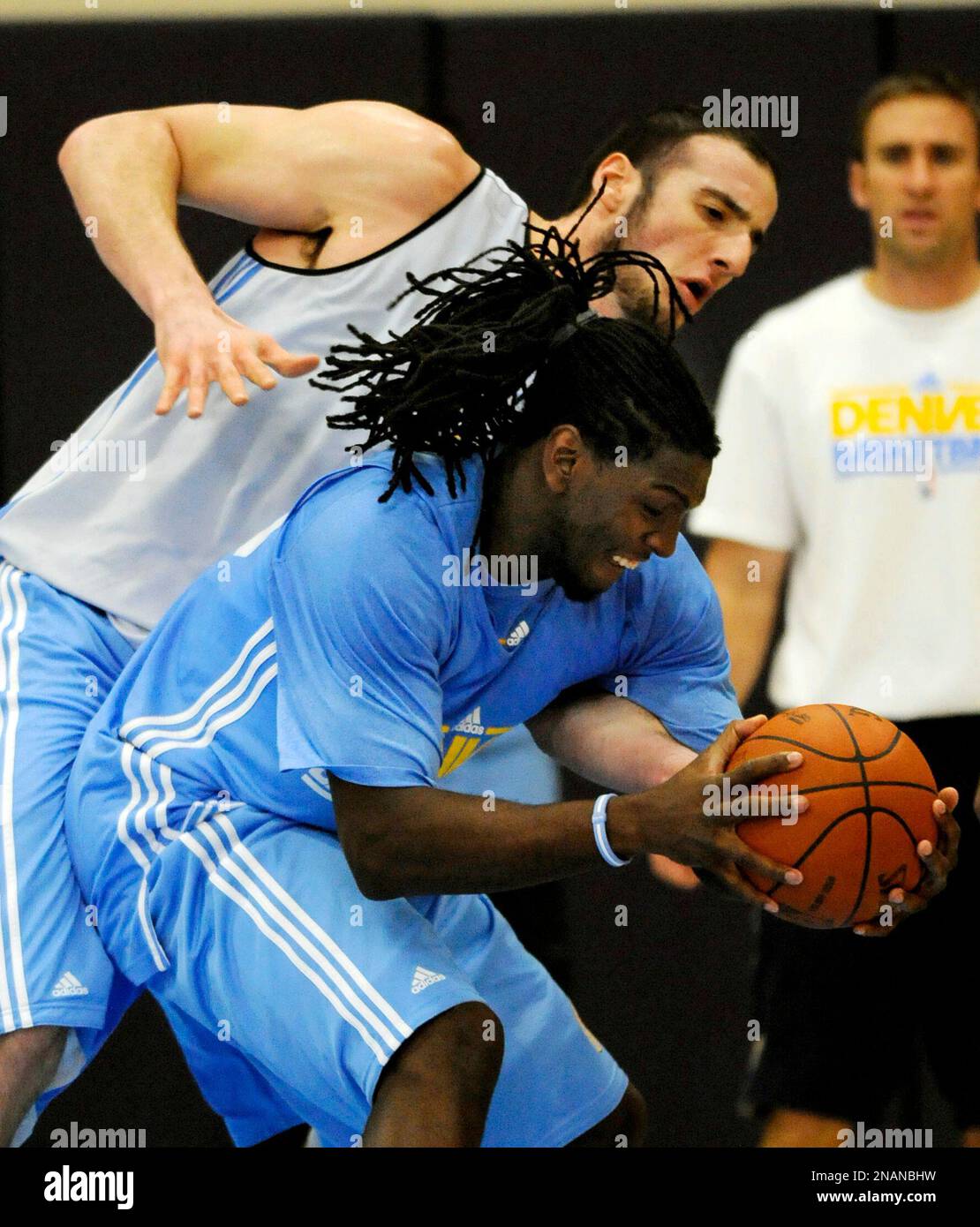 Denver Nuggets rookie forward Faried, front, is pressured by