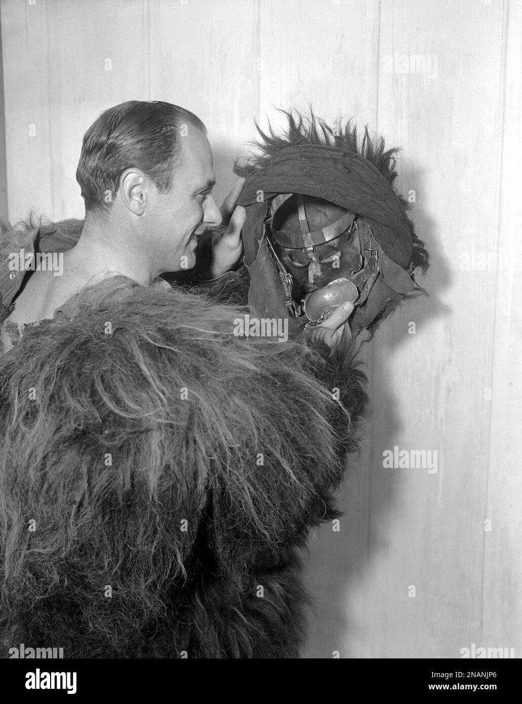Steve Calvert, Hollywood gorilla man, shows how the head of his outfit