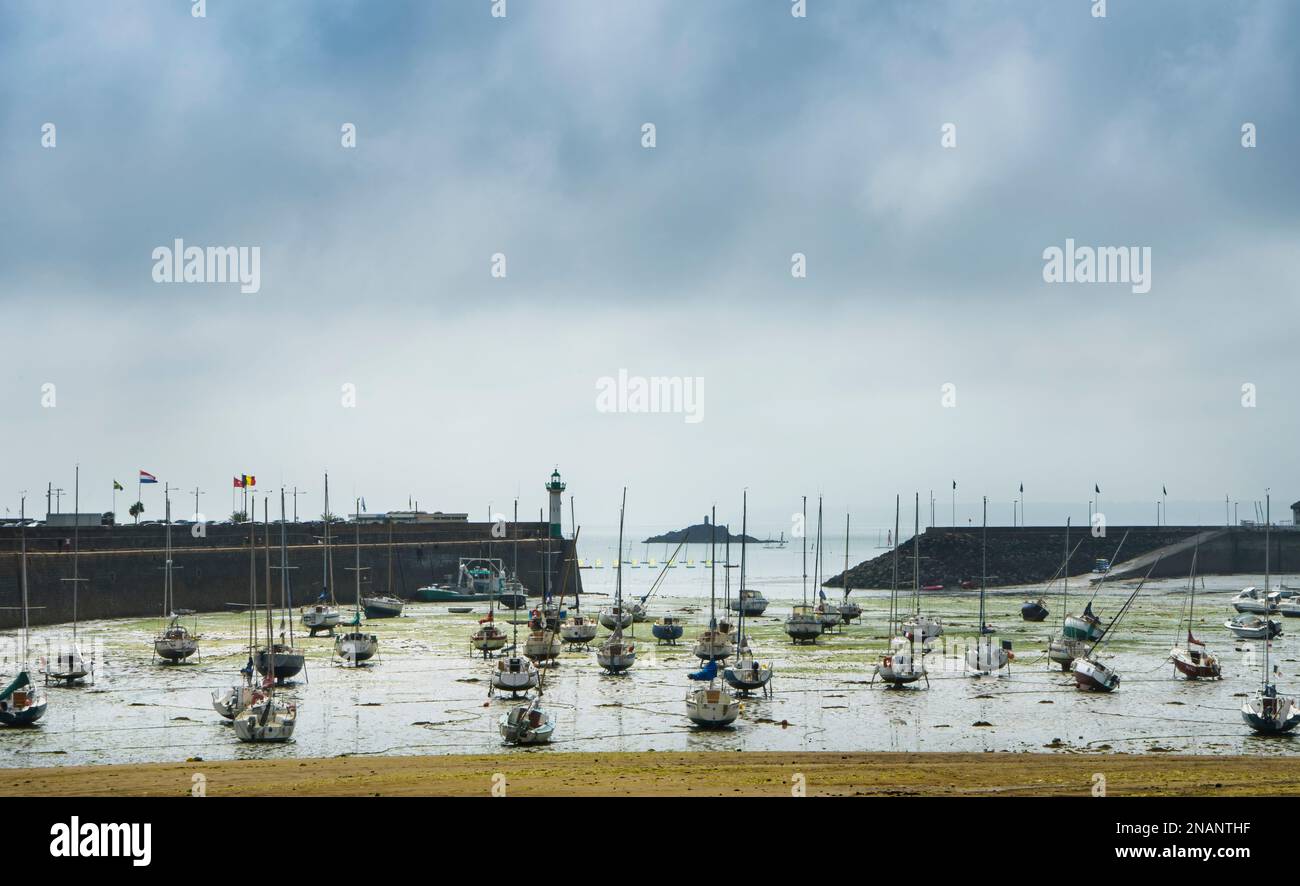 View of the harbor at low tide in the French town of Saint Quay Portrieux with stranded ships. Stock Photo