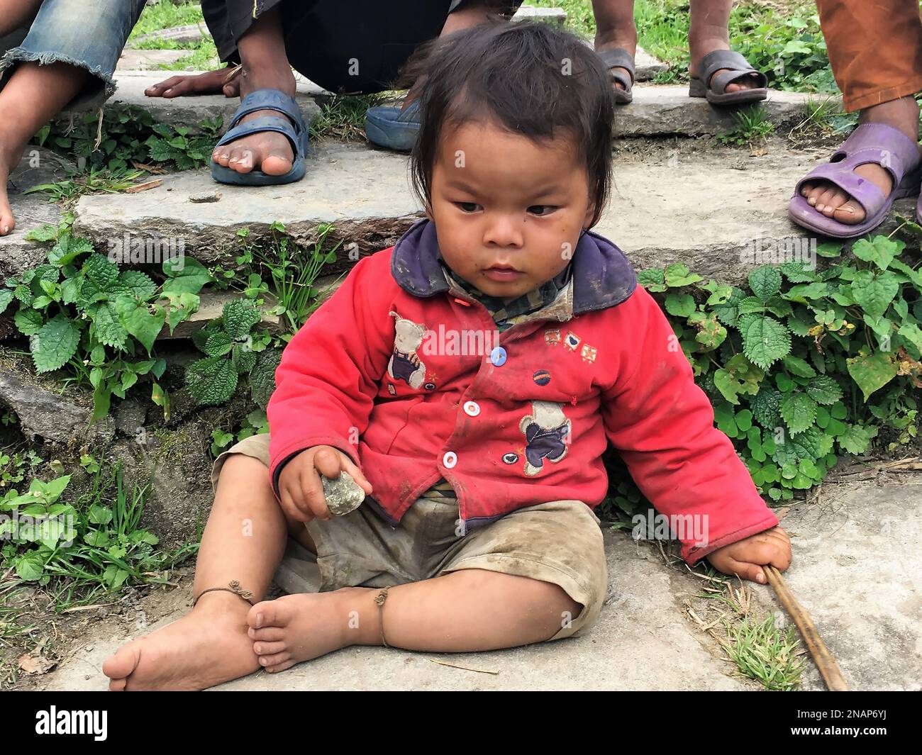 Ghorepani, Nepal,October 11th 2016 - A Nepali child in the middle of his play time near the village of Ghorepani on the Annapurna Circuit trek Stock Photo