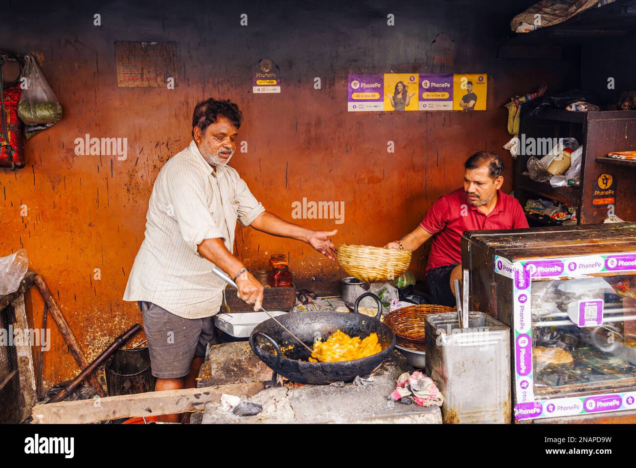 Street food being prepared and cooked in a roadside shop in Fariapukur, Shyam Bazar, a suburb of Kolkata, West Bengal, India Stock Photo