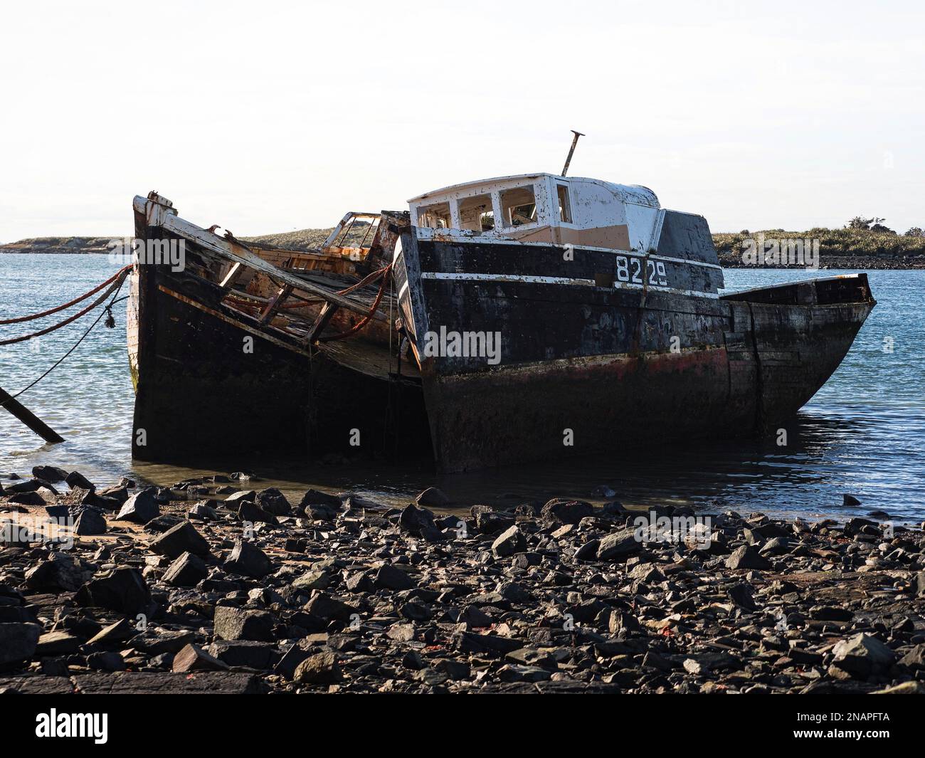 Remains ruins of old historical capsized tilted fishing boat ship wreck