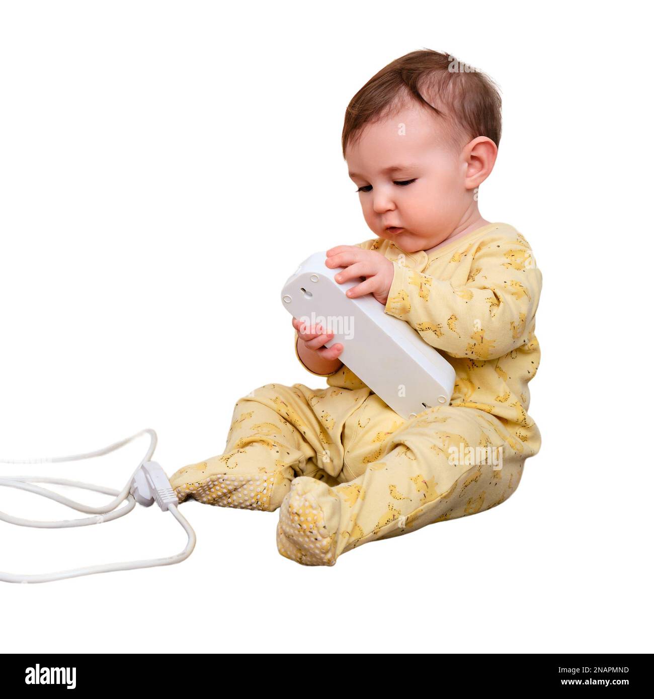 Toddler baby boy plays with electric wires while sitting on the floor