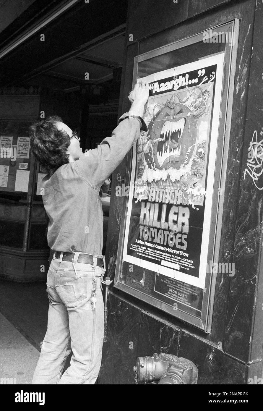 Beacon theater assistant manager Chuck Dishian pastes up a poster on ...