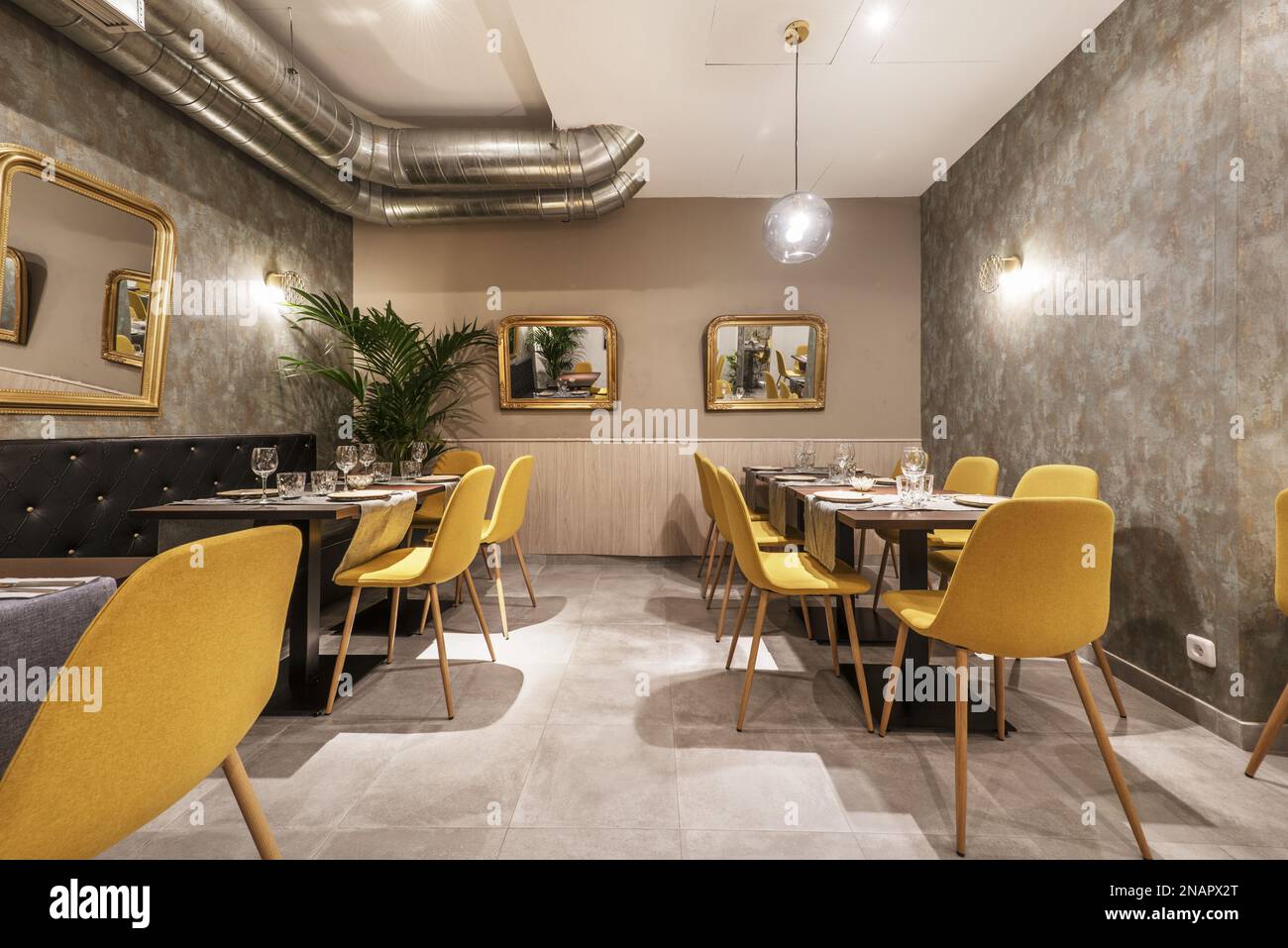 Hall of a restaurant with tables with glassware and crockery and