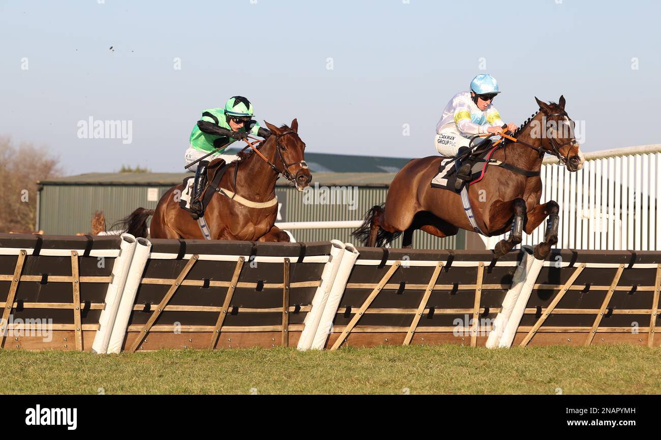Plumpton, UK. 13th Feb, 2023. Thirtyfourstitches ridden by Charlie Hammond (R) clear the final hurdle ahead of Kotmask and Nail Houlihan to win the Placesetting Equipment Hire Handicap Hurdle at Plumpton Racecourse. Credit: James Boardman/Alamy Live News Stock Photo