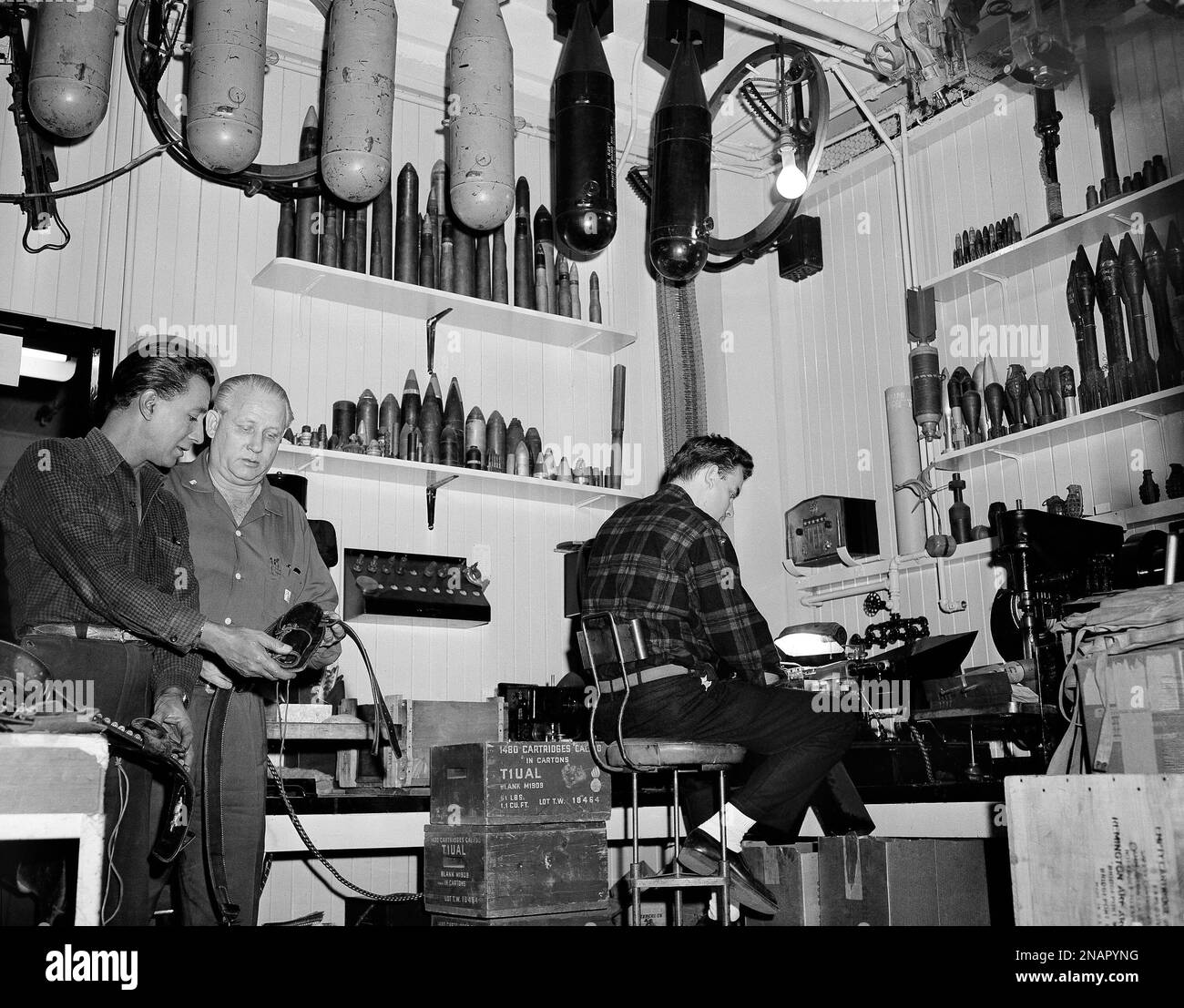 A gun holster is studied by actor and gun expert Rodd Redwing (left ...