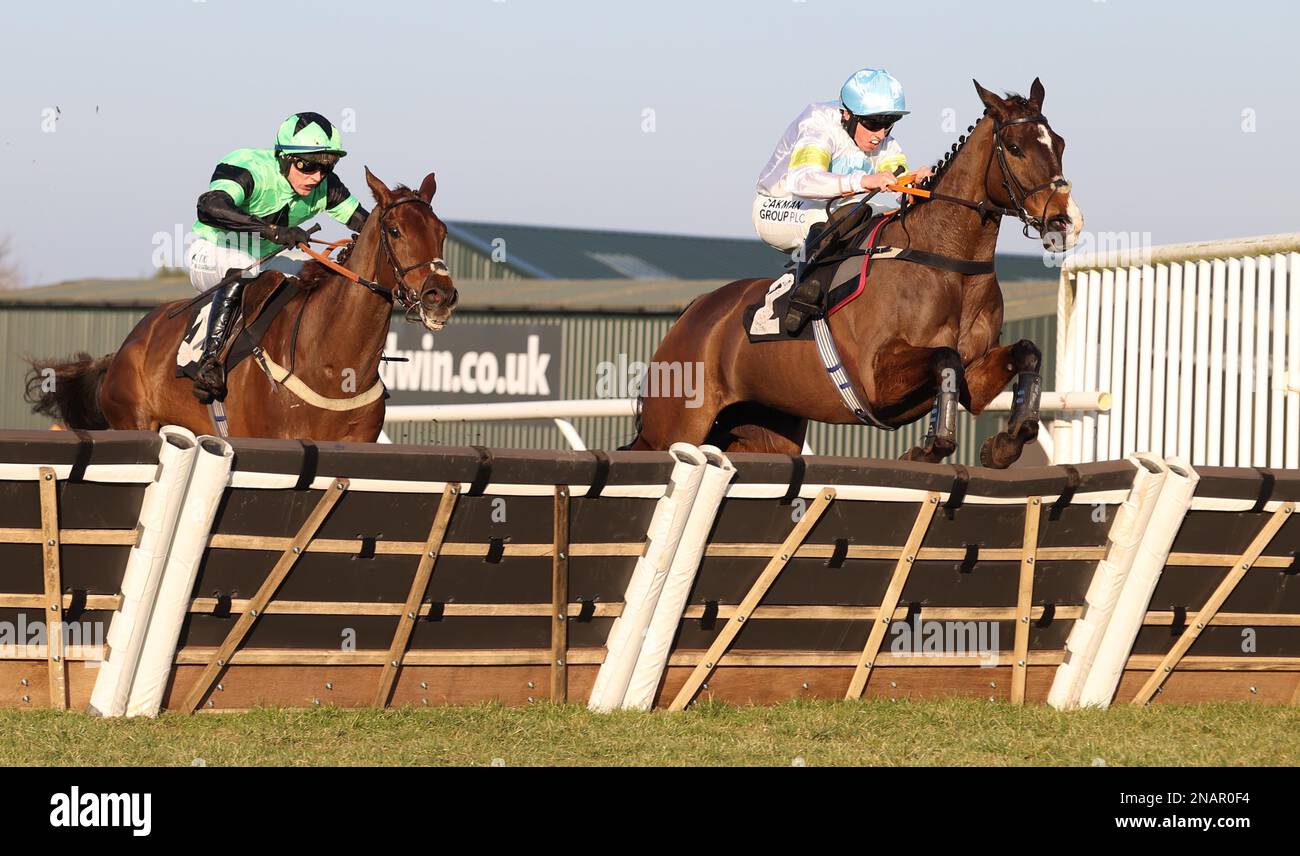 Plumpton, UK. 13th Feb, 2023. Thirtyfourstitches ridden by Charlie Hammond (R) clear the final hurdle ahead of Kotmask and Nail Houlihan to win the Placesetting Equipment Hire Handicap Hurdle at Plumpton Racecourse. Credit: James Boardman/Alamy Live News Stock Photo