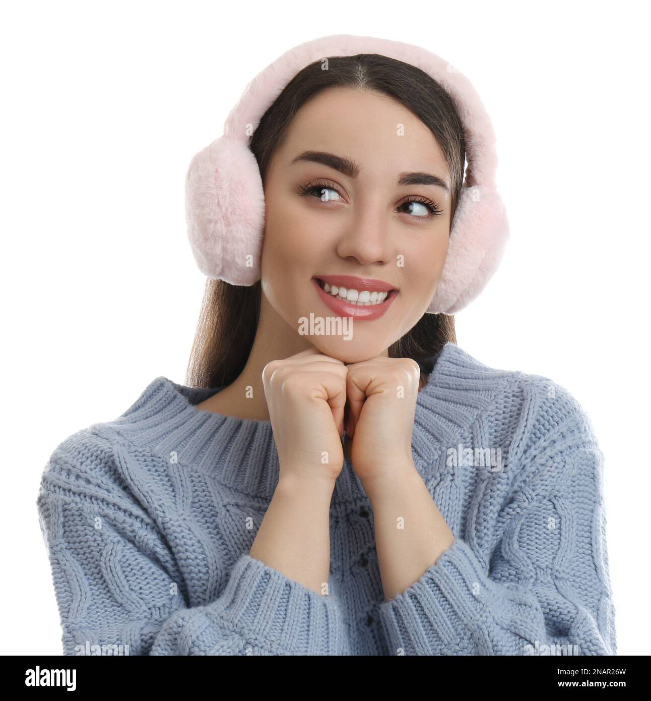 Beautiful young woman wearing earmuffs on white background Stock Photo