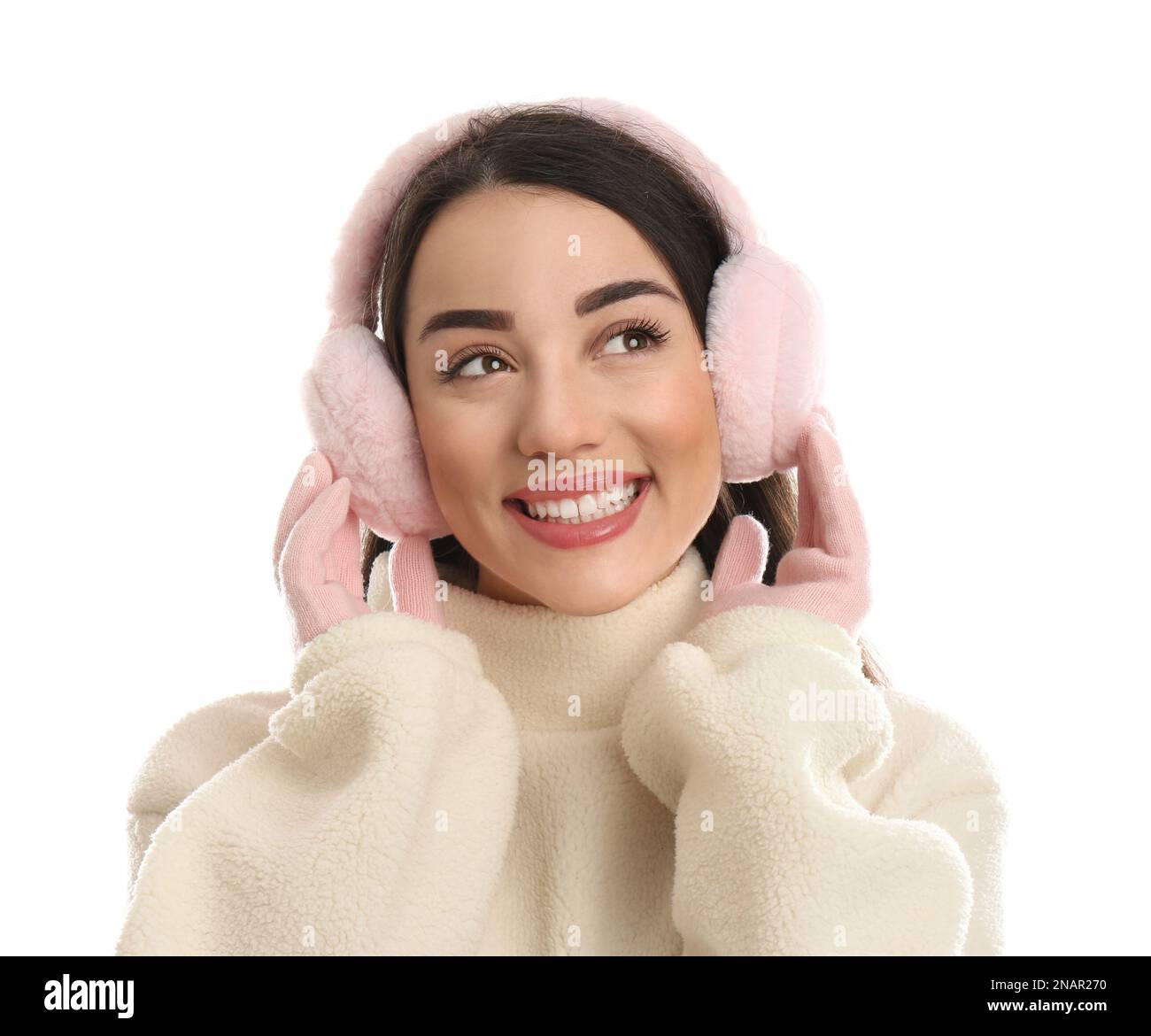 Beautiful young woman wearing earmuffs on white background Stock Photo