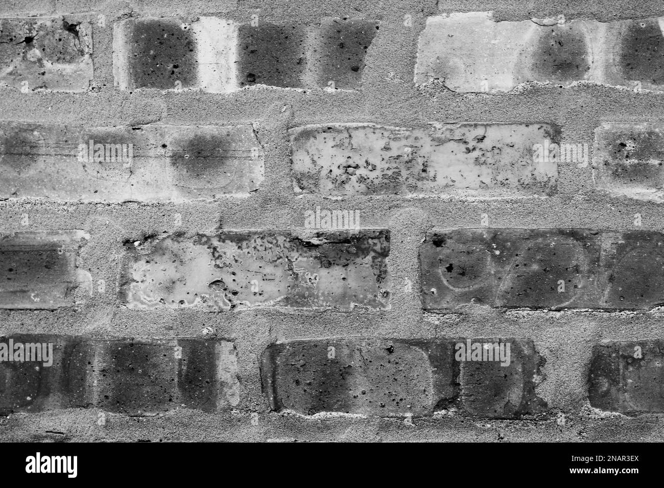 A common typical brick wall with layers of bricks in a black and white