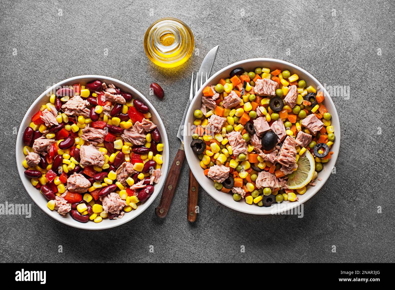 Healthy tuna salads mixed with corn, peppers, carrot, peas and beans on