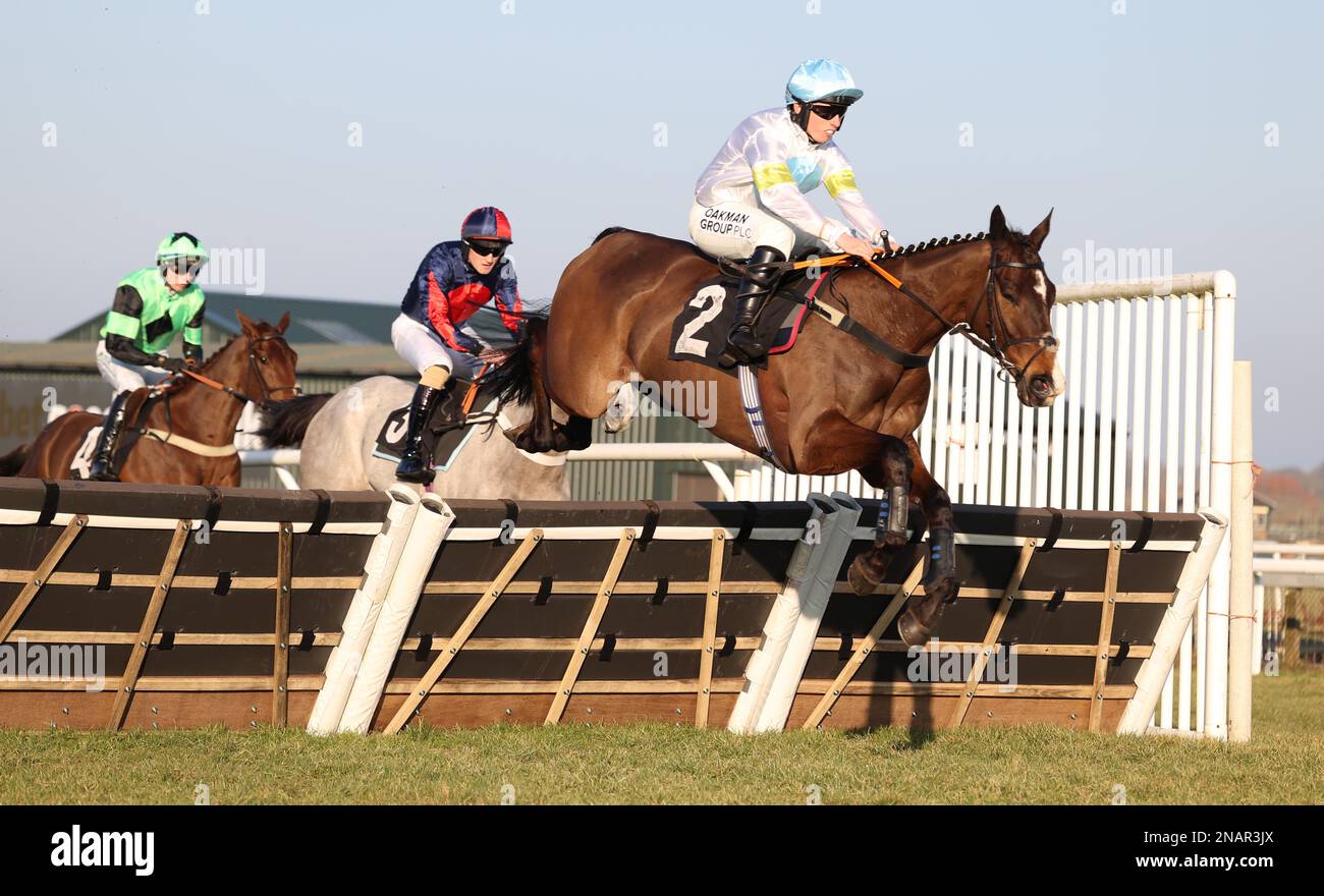 Plumpton, UK. 13th Feb, 2023. Thirtyfourstitches ridden by Charlie Hammond (R) clear an early hurdle before winning the Placesetting Equipment Hire Handicap Hurdle at Plumpton Racecourse. Credit: James Boardman/Alamy Live News Stock Photo