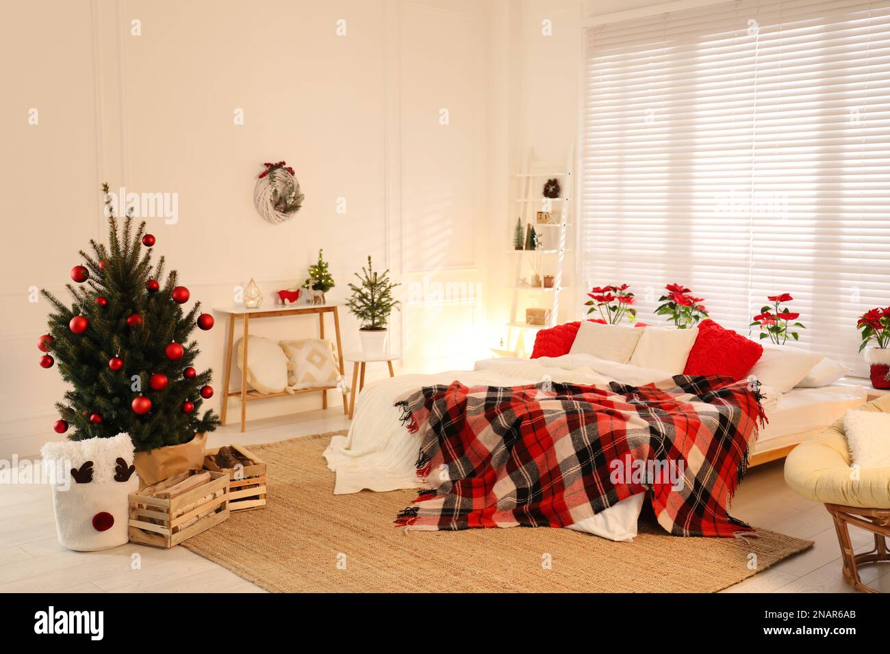 Beautiful decorated Christmas tree in bedroom. Interior design Stock