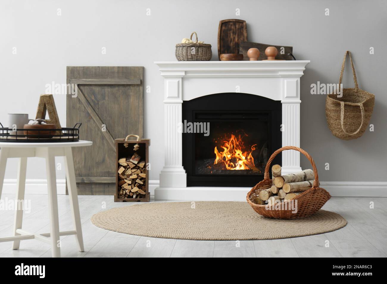 Cozy living room interior with firewood and white fireplace Stock Photo ...