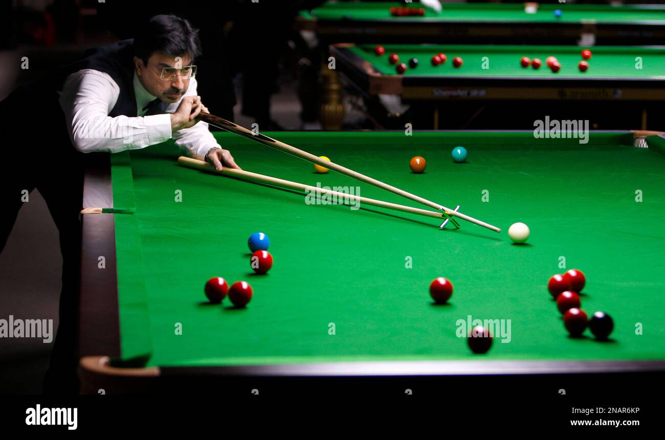Indias Yasin Merchant eyes the ball to play a shot during a round robin league match against Englands Martin ODonnell, unseen, at the International Billiards and Snooker Federation (IBSF) World Snooker Championship