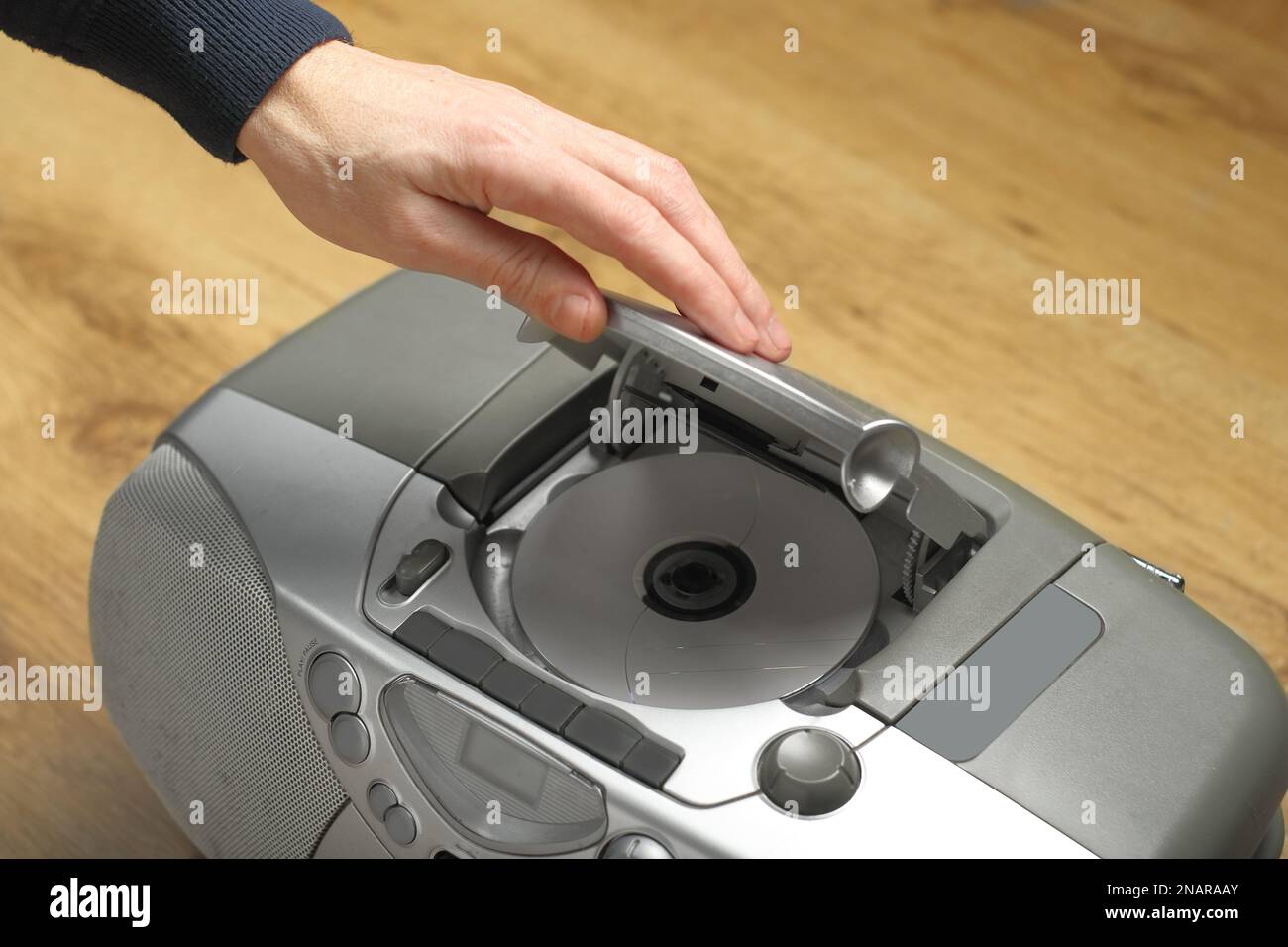 person closes cd player with compact disc inside Stock Photo Alamy