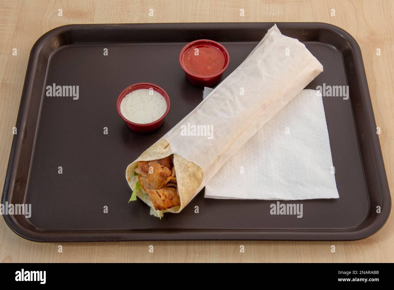 A typical European kebab restaurant rolled durum with sauces on a brown