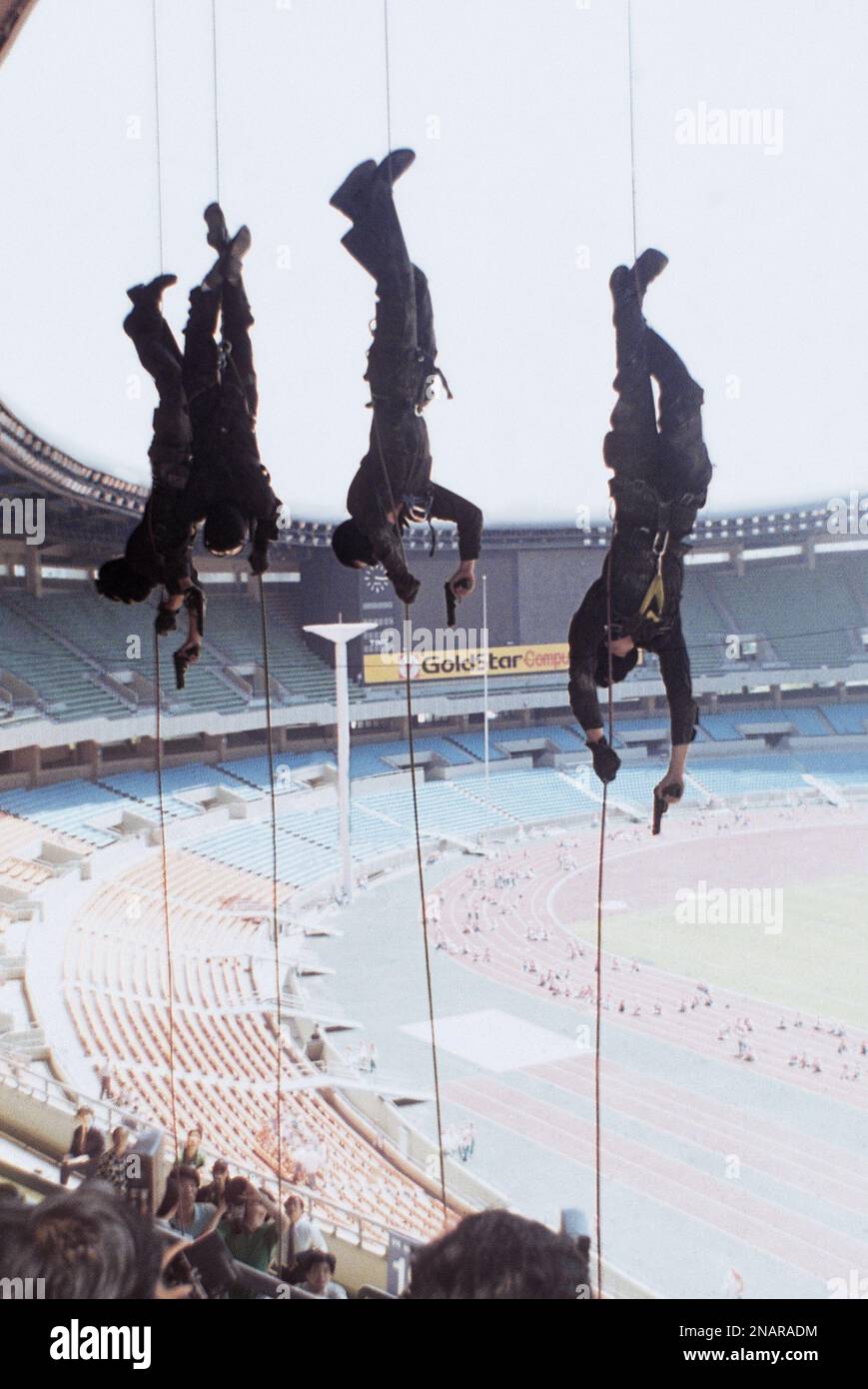 Anti terrorist commandos slide down ropes during a training exercise at ...
