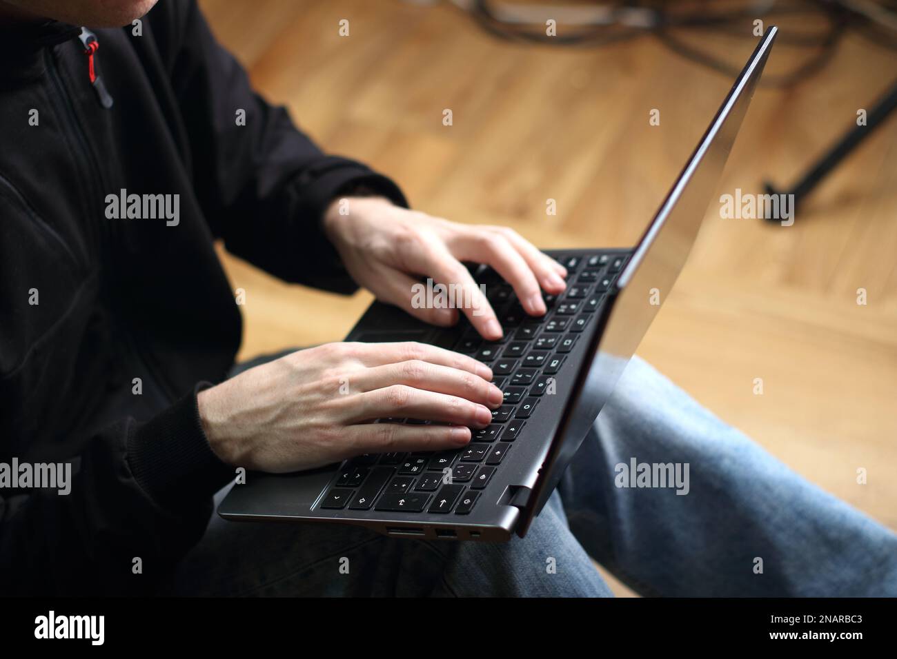 person is typing on a laptop keyboard Stock Photo