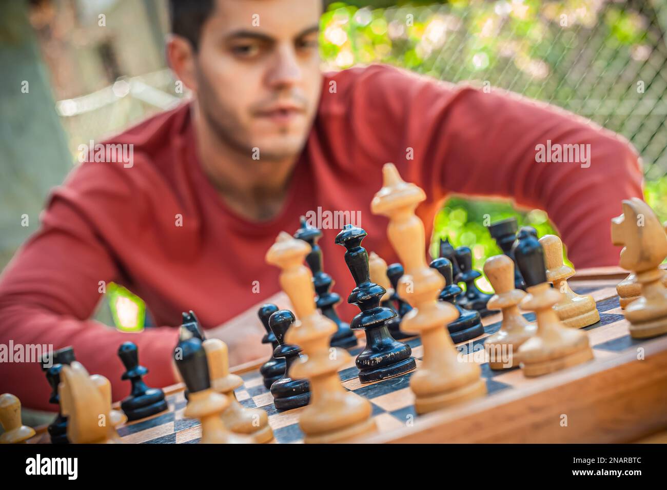 man studying the next chess move Stock Photo - Alamy