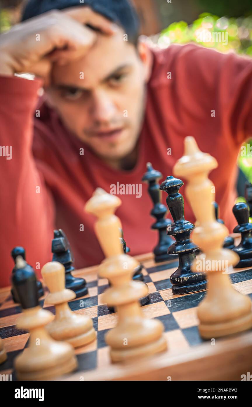 A Man Is Playing Chess Thinking About The Next Move Stock Photo - Download  Image Now - iStock