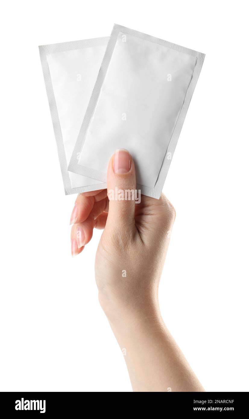 Woman holding medicine sachets on white background, closeup Stock Photo