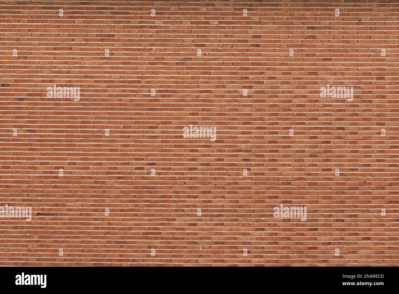 A surface of clay-colored bricks laid horizontally on the facade of a building. vector bricks background texture Stock Photo
