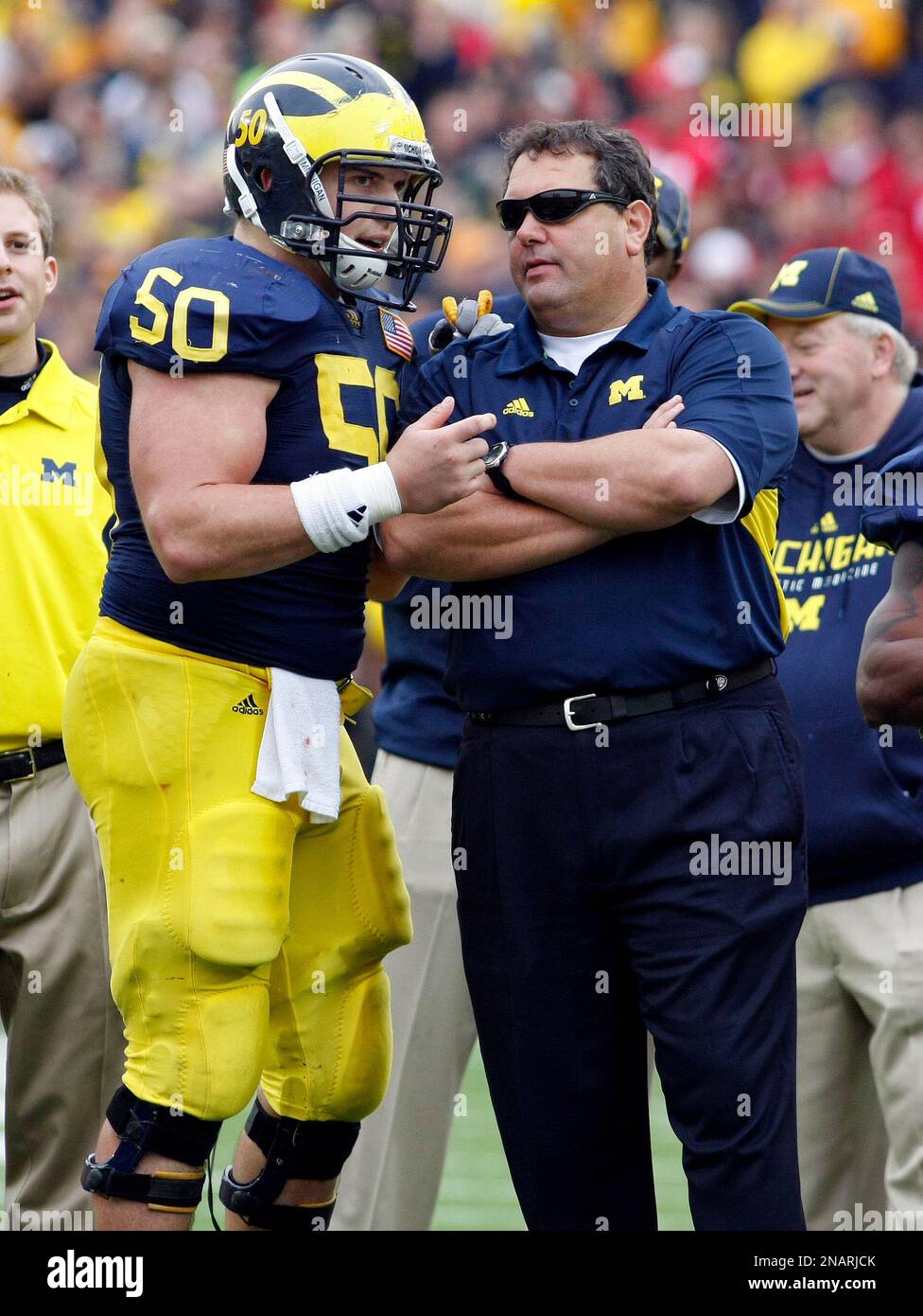 Michigan offensive lineman David Molk (50) shares a word with head