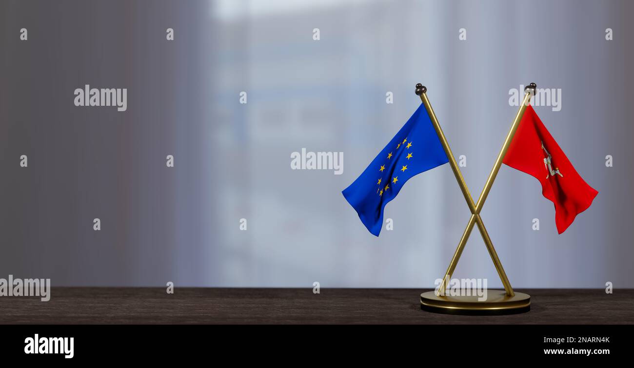 Isle of Mann and Europe flags on table. Negotiation between Isle of Mann and EU. on little blur background. 3D work and 3D image Stock Photo