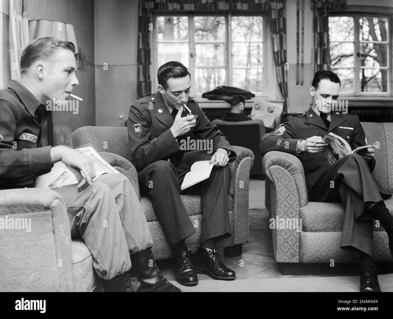 Earl S. Eisenhower, 25 year-old nephew of the U.S. President, center, sits smoking  cigarettes, in his company dayroom in Rothwesten, near Kassel, Germany on  Oct. 30, 1959, together with his buddies PFC