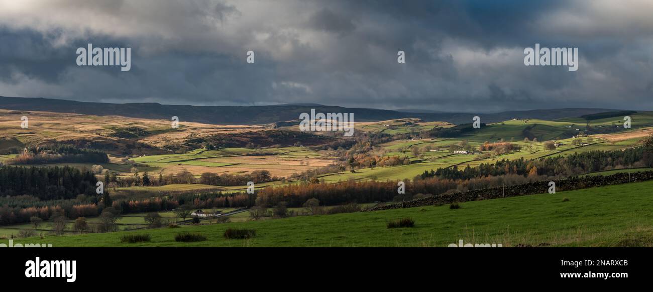 Dramatic lighting conditions on this paroramic view of Upper Teesdale from Stable Edge, taking in Holwick (left) to Ettersgill (Right). Stock Photo