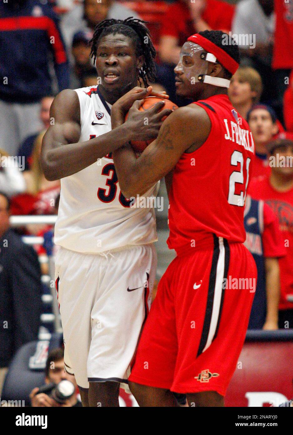 San Diego State's Jamaal Franklin (21) and Arizona's Angelo Chol (30