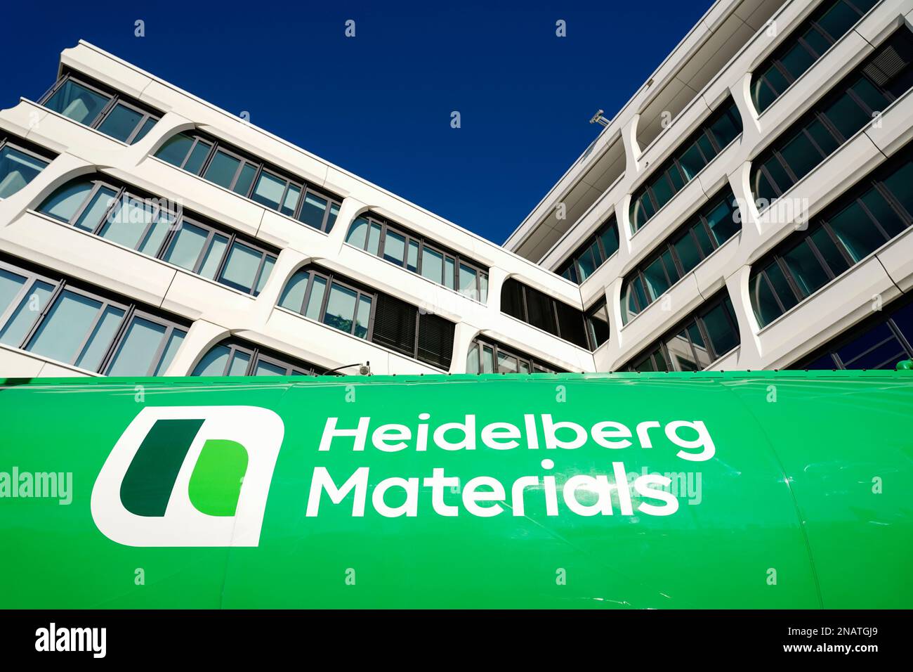 Heidelberg, Germany. 13th Feb, 2023. A company logo of the building materials group "Heidelberg Materials", formerly "HeidelbergCement", is attached to a truck trailer parked in front of the company headquarters. Credit: Uwe Anspach/dpa/Alamy Live News Stock Photo