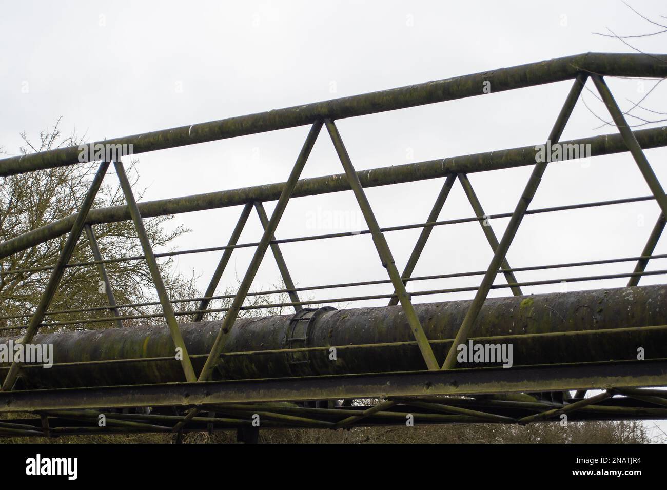 Maple Cross, Hertfordshire, UK. 12th February, 2023. Huge pipeworks above the Grand Union Canal feeding into the sewage treatment plant. It has been reported in the inews this week that HS2 Ltd, the Government backed company responsible for building the new High Speed 2 railway, have signed an agreement with Thames Water whereby HS2 can send sewage and other 'contaminated' water to the Maple Lodge Sewage Treatment Works (pictured) in Rickmansworth, Hertfordshire which borders Maple Cross. The agreement allows HS2 to send both human waste and 'contaminated' water from their nearby construction Stock Photo