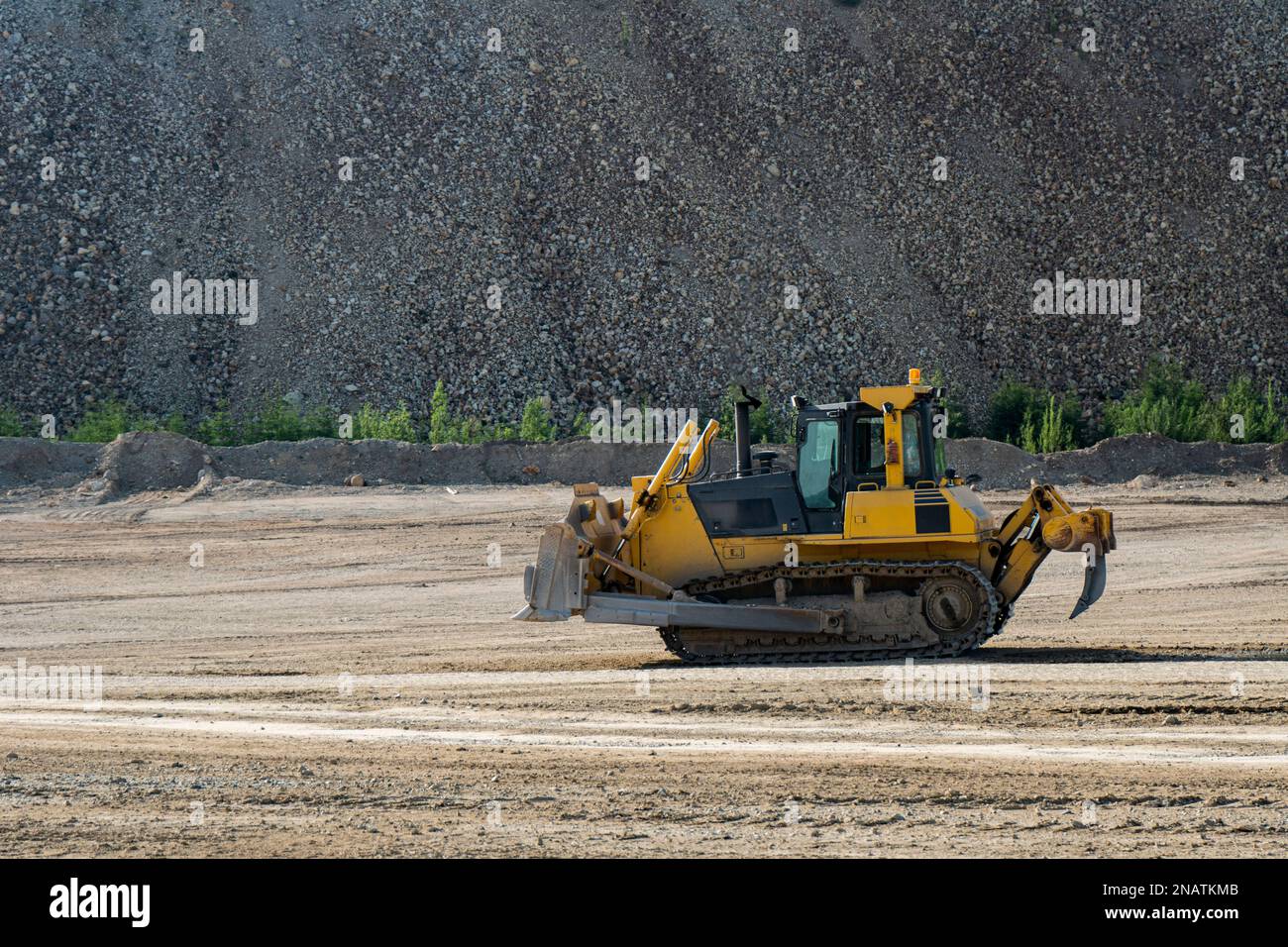 Bulldozer At A Construction Site Shovels Mountain Soil Into A Heap ...