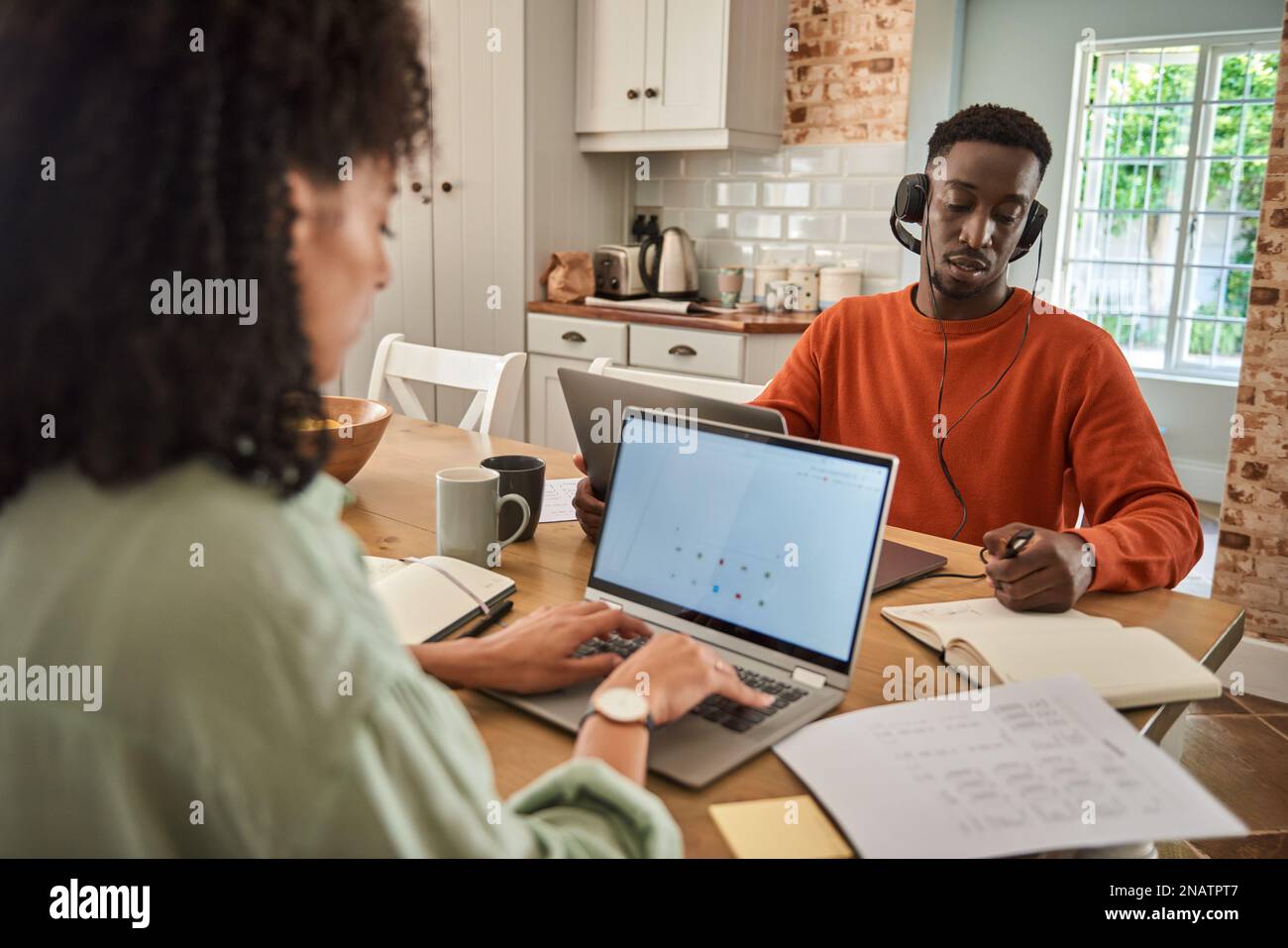 Young multiracial couple working remotely online from home Stock Photo