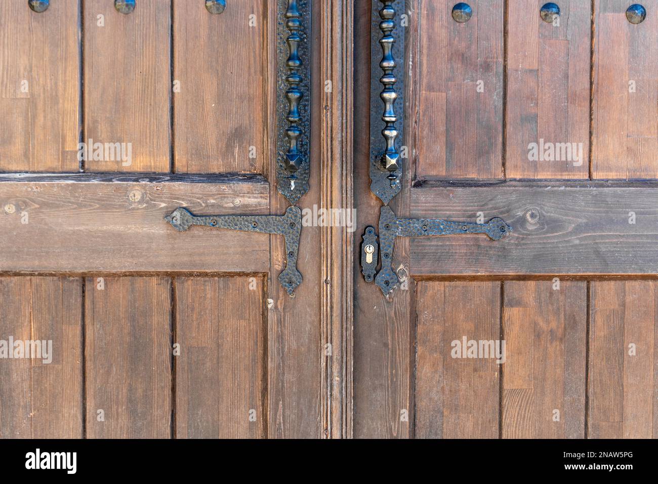 Old, faded classical, brown, wooden door with iron door handle. Door ...