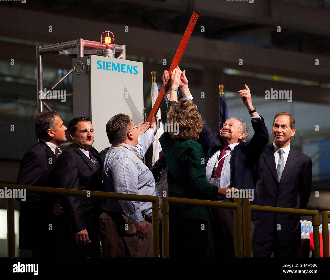 Siemens executives and their guests throw a switch during the Siemens ...
