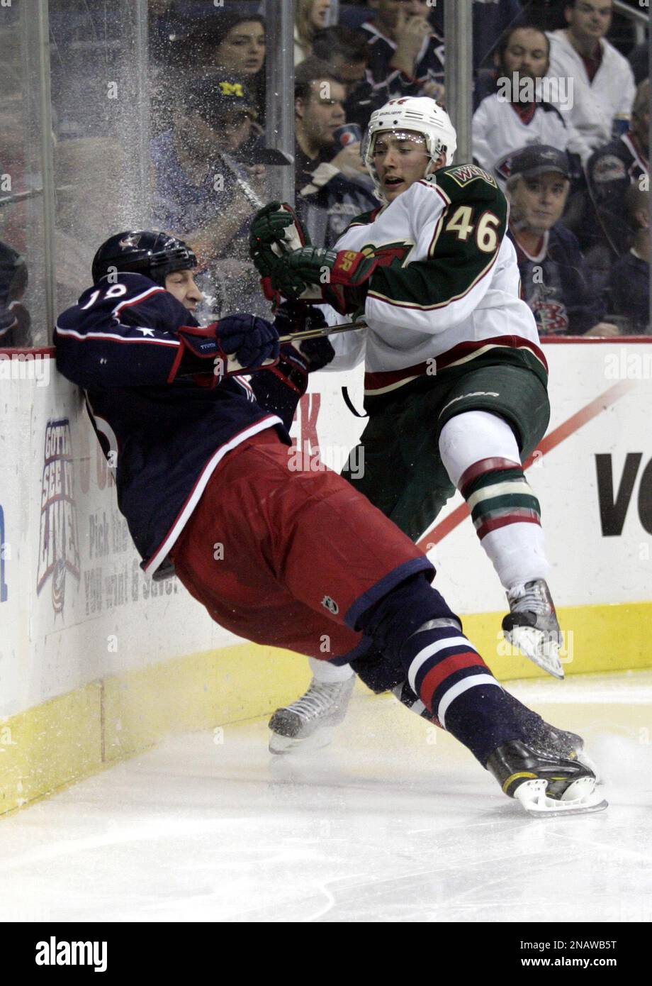 Minnesota Wild's Jared Spurgeon, right, checks Columbus Blue Jackets' R