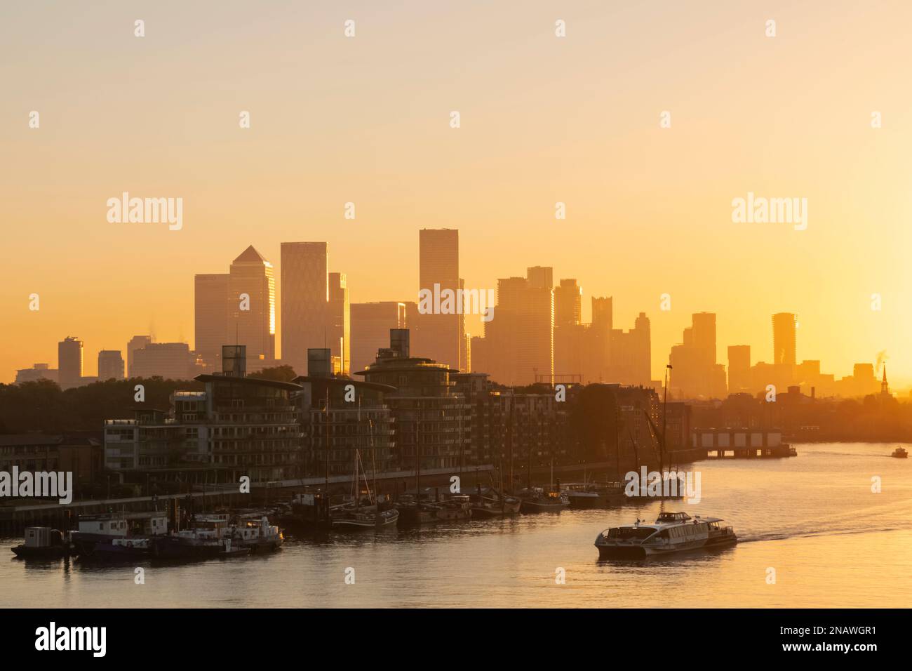 England, London, Sunrise over Canary Wharf Skyline and River Thames ...