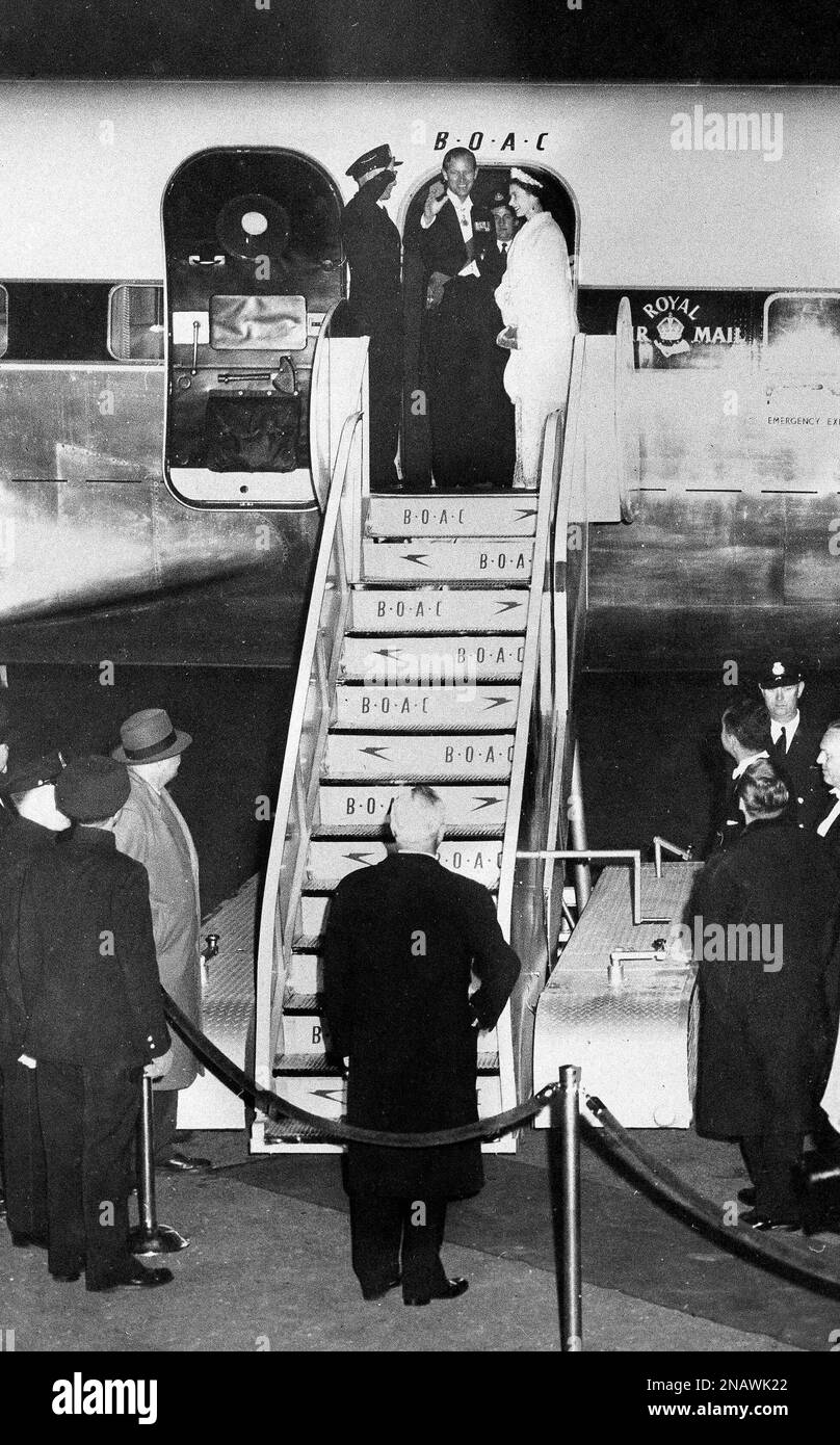 Britain's Prince Philip waves farewell as Queen Elizabeth II stands