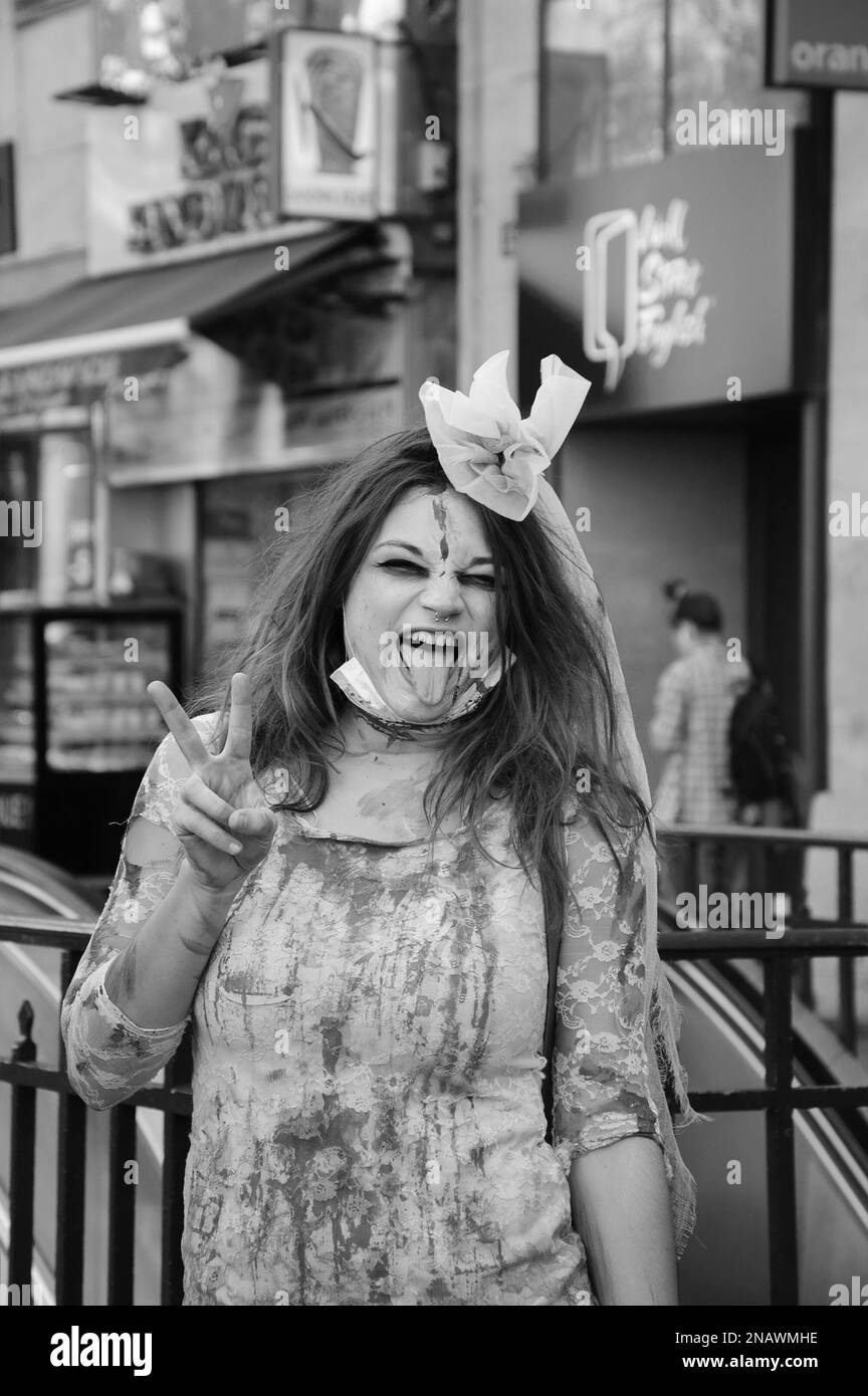 PARIS, FRANCE - OCTOBER 3, 2015: Young woman in zombie bride dress makes victory sign during Zombie parade at Place de la Republique. Zombie Walk is a Stock Photo