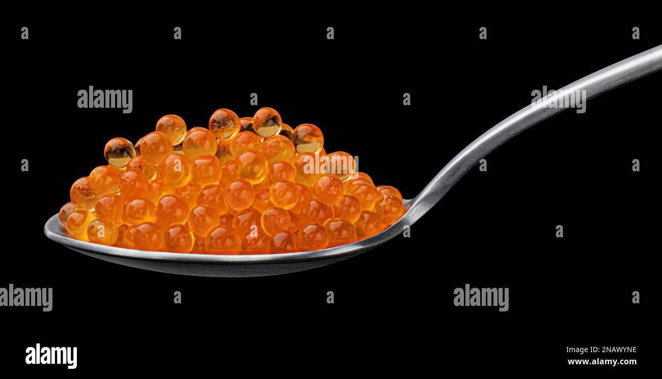 Red caviar on spoon for sushi isolated on black background Stock Photo