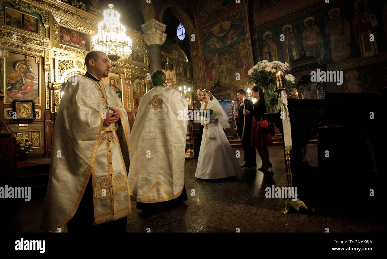Orthodox priests leading the wedding ceremony of Mina, 27 and Tsenko Denchevi at St. Nedelya